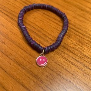 Clay bead bracelet with metal smiley face charm